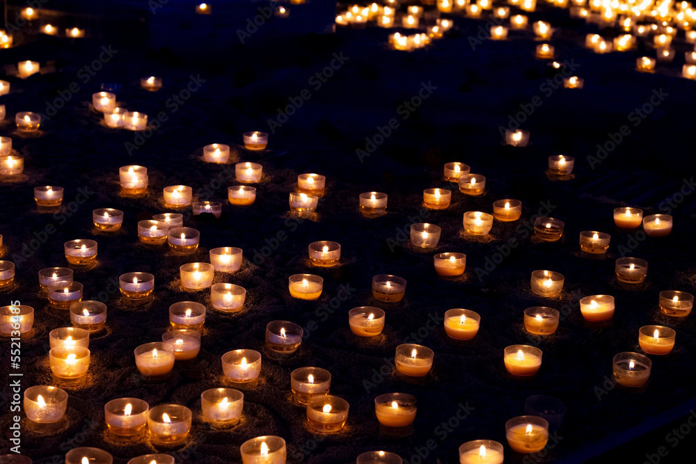 Candles, numerous candles on a table and bokeh effect.