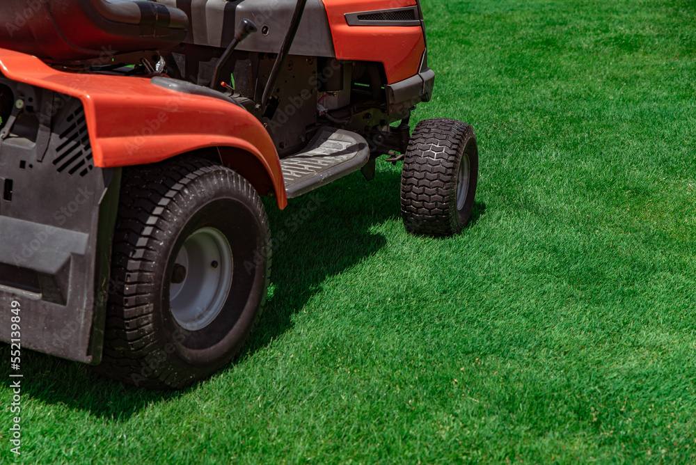 Professional lawn mower on the football field Professional lawn mower on the football field