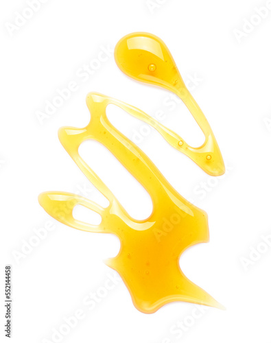 Foto Sweet honey drop isolated on white background