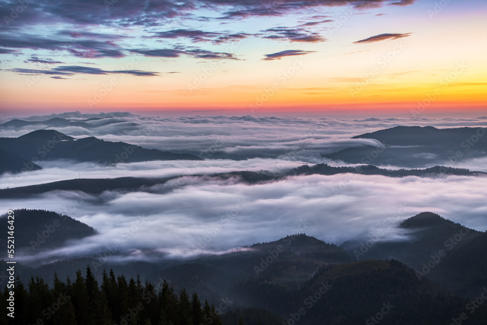 Panorama with amazing sunrise. Landscape with high mountains. Fields and meadow are covered with morning fog and dew. Touristic resort Carpathian national park, Ukraine Europe. Natural scenery.