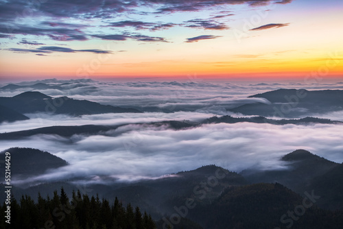 Panorama with amazing sunrise. Landscape with high mountains. Fields and meadow are covered with morning fog and dew. Touristic resort Carpathian national park, Ukraine Europe. Natural scenery. © Vitalii_Mamchuk