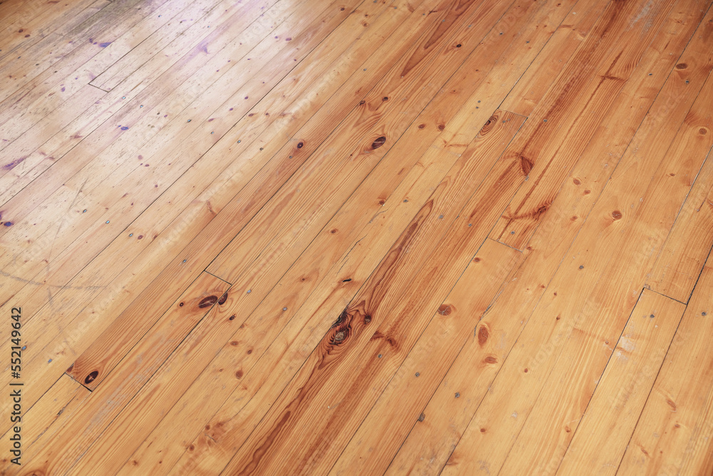 Fototapeta premium Yellow colored old shabby wooden floor background. Weathered hardwood material with planks and boards.