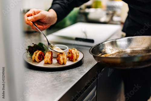 man chef cooking tasty shrimp on kitchen