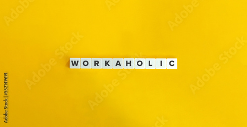 Workaholic Word and Banner. Ergomania and Workaholism Concept. Block Letter Tiles on Yellow Background. photo