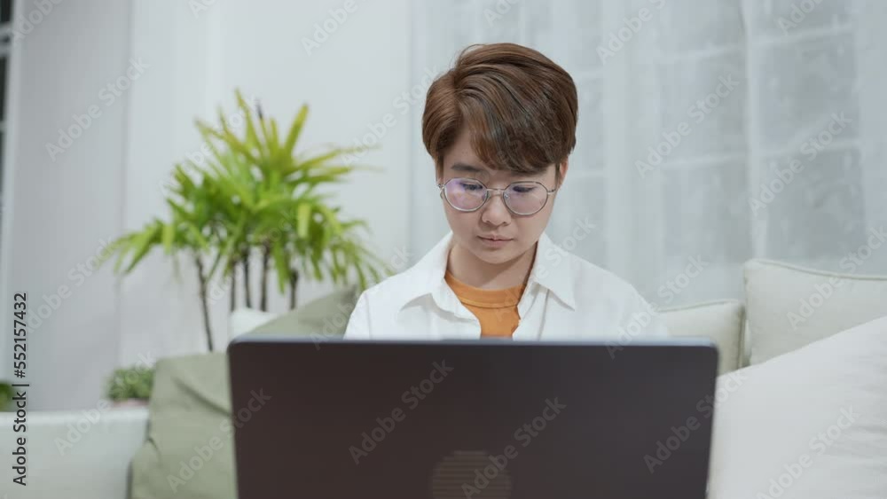 Holiday concept of 4k Resolution. Asian women playing laptops together in the living room. Young women are in a mutual lesbian love relationship. Holiday concept of 4k Resolution. Asian women playing laptops together in the living room. Young women are in a mutual lesbian love relationship.