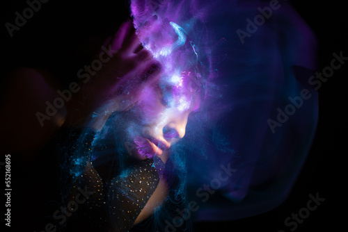 Abstract photography in the style of light painting. girl on a black background