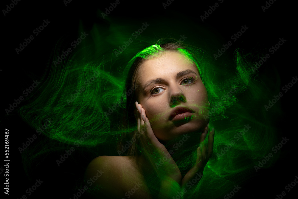 Abstract photography in the style of light painting. girl on a black background