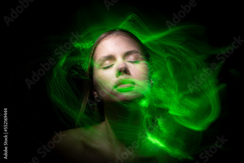Abstract photography in the style of light painting. girl on a black background
