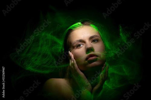 Abstract photography in the style of light painting. girl on a black background