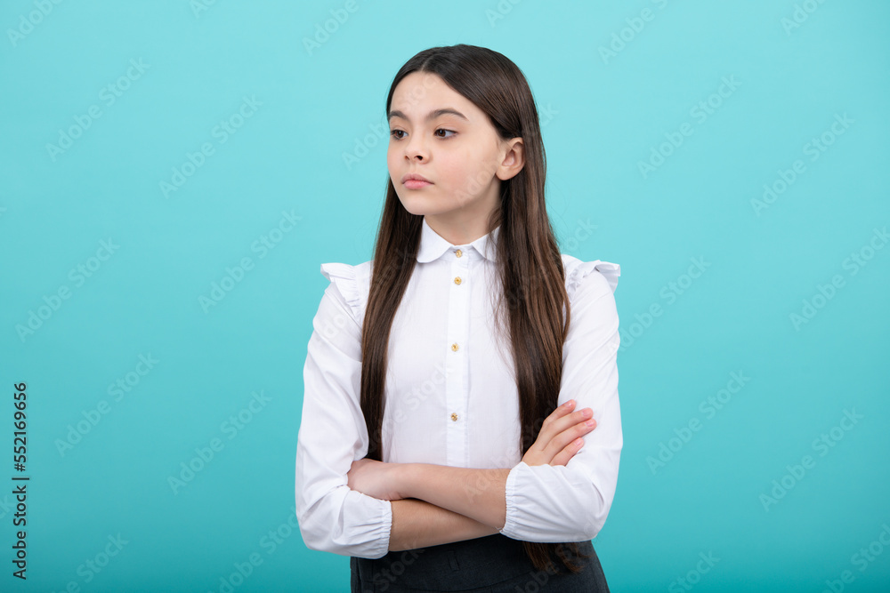 Portrait of caucasian teen girl with arms folded, isolated on blue background. Cute teenager child. Portrait of caucasian teen girl with arms folded, isolated on blue background. Cute teenager child.