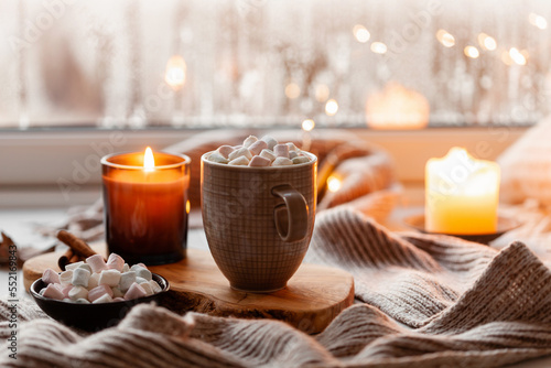 Obraz na płótnie warm cozy window arrangement, winter or autumn concept, coffe, candles throw lights w salonie