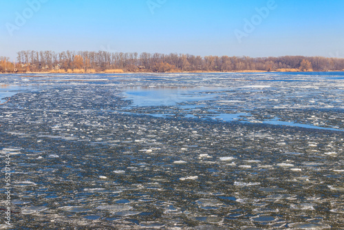 View of a lake with melting ice at spring