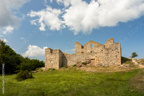 The ruins of an old house against the blue sky on a summer day