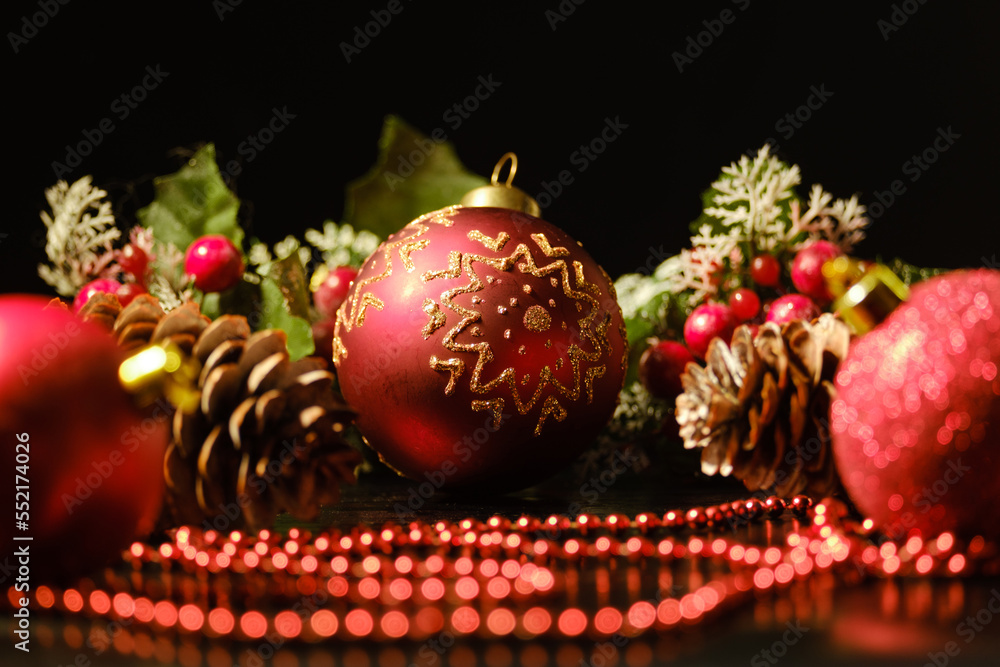 Christmas ball with gold ornaments and New Year's decorations on a black background