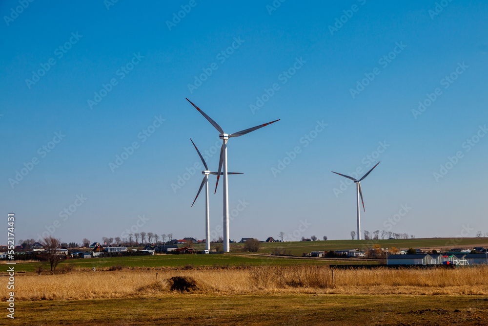 Wind turbines in a village. Renewable energy Wind turbines in a village. Renewable energy
