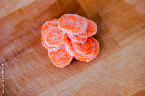 Frozen carrot slices on the wooden background