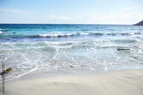 Sand beach, summer sea with blue sky. Sea water with white wave. Cala azzurra beach, Favignana island, Trapani, Sicily, Italy. A beautiful seascape