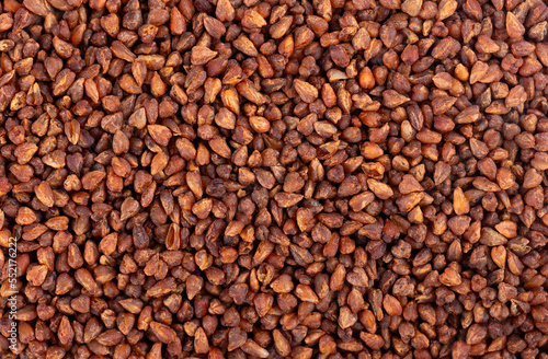 Buckwheat tea background. Whole roasted buckwheat grains. Fagopyrum tataricum.