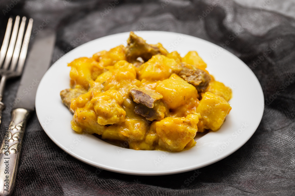 Beef stew with sweet potato and curry sauce on plate Beef stew with sweet potato and curry sauce on plate