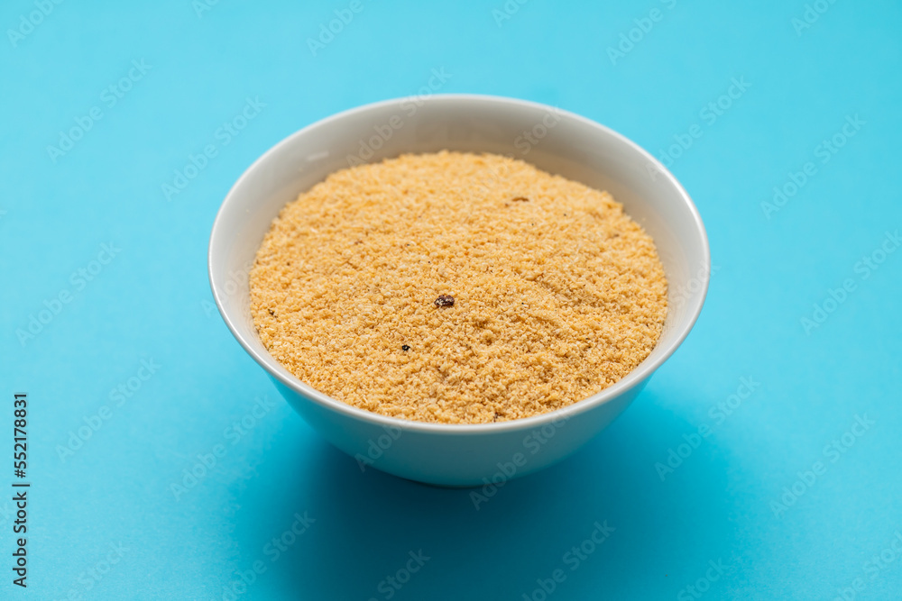 Farofa, typical brazilian manioc flour side dish on blue Farofa, typical brazilian manioc flour side dish on blue