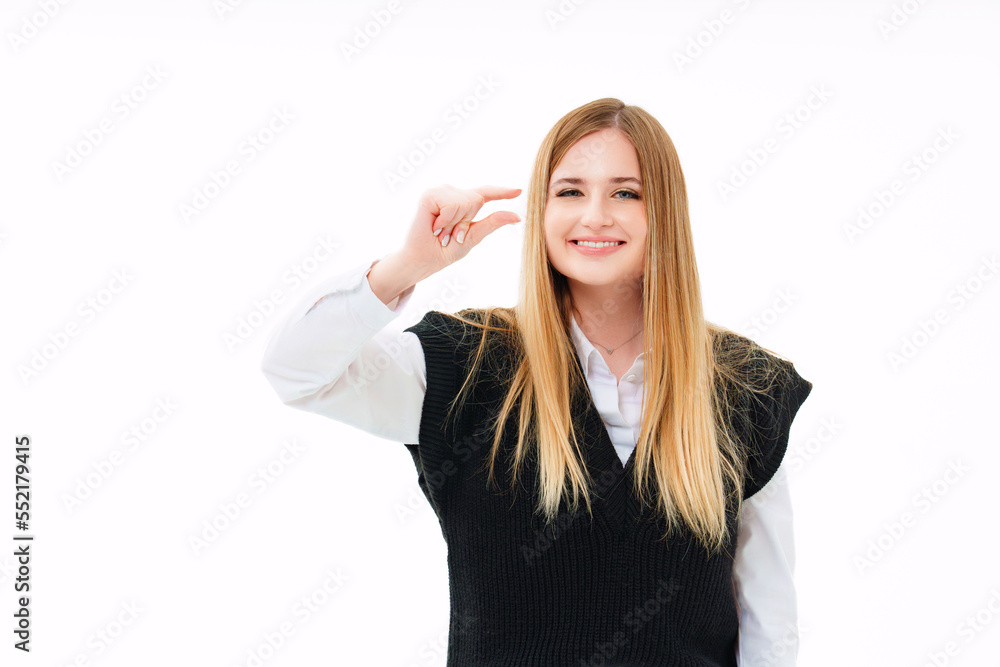 an attractive blonde in a black vest shows her fingers a little sign. an attractive blonde in a black vest shows her fingers a little sign.