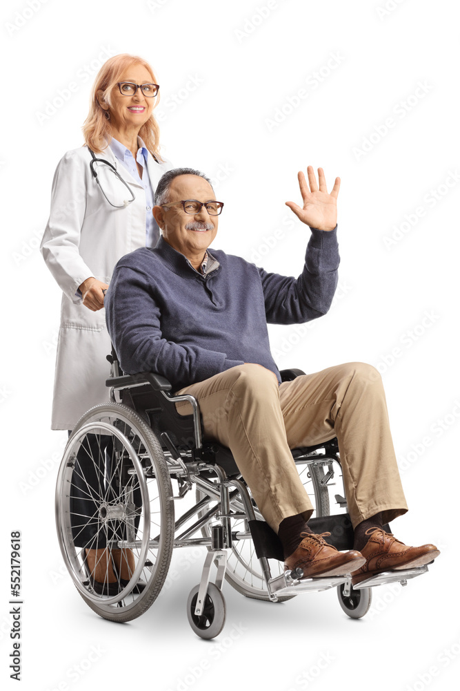 Male patient sitting in a wheelchair and waving and female doctor standing behind Male patient sitting in a wheelchair and waving and female doctor standing behind