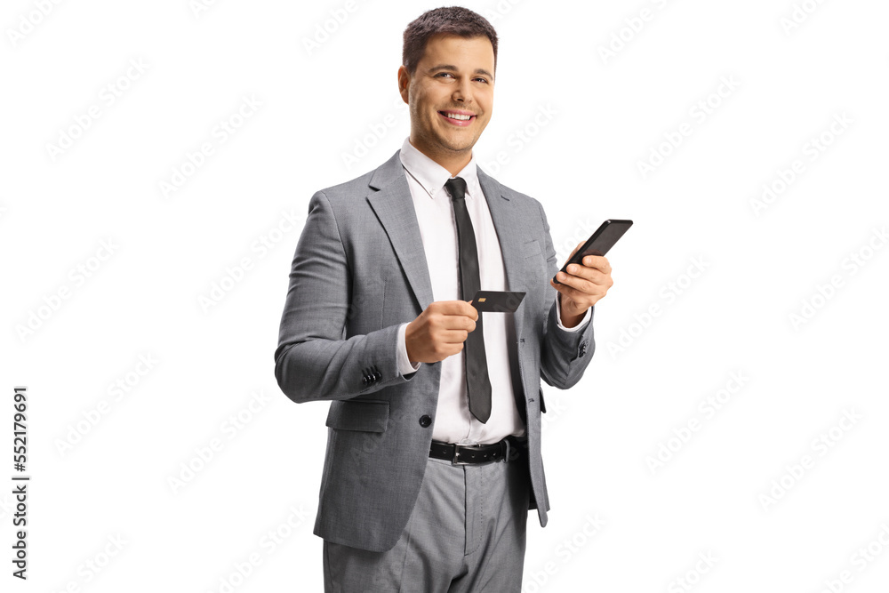 Young professional man using a smartphone and a credit card Young professional man using a smartphone and a credit card