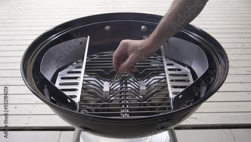 Lighting Fire starter igniting fuel in a Kettle Charcoal BBQ