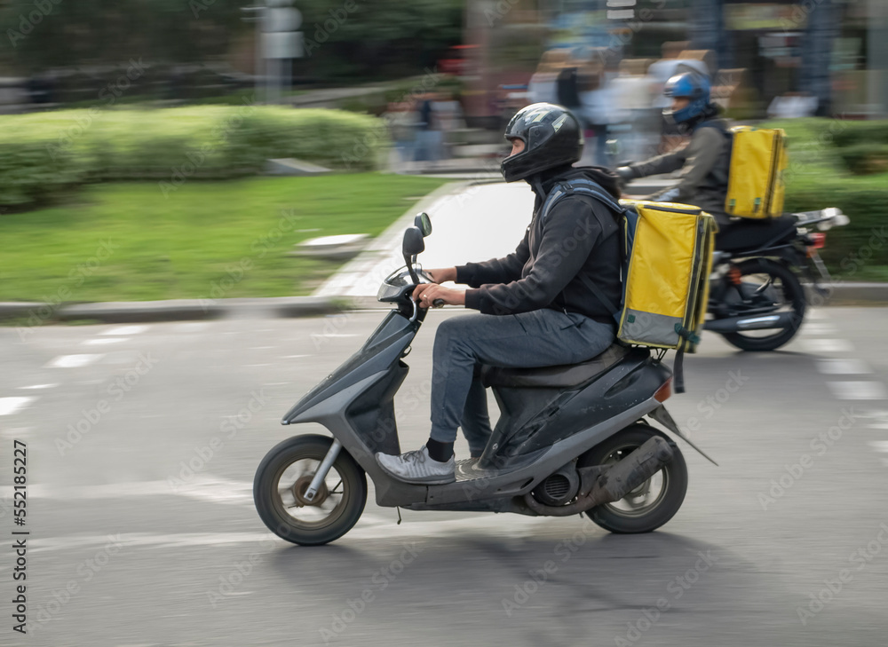 Abstract blur image of scooter courier