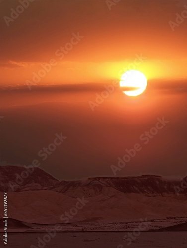 Scenic view of desert against sky at sun set