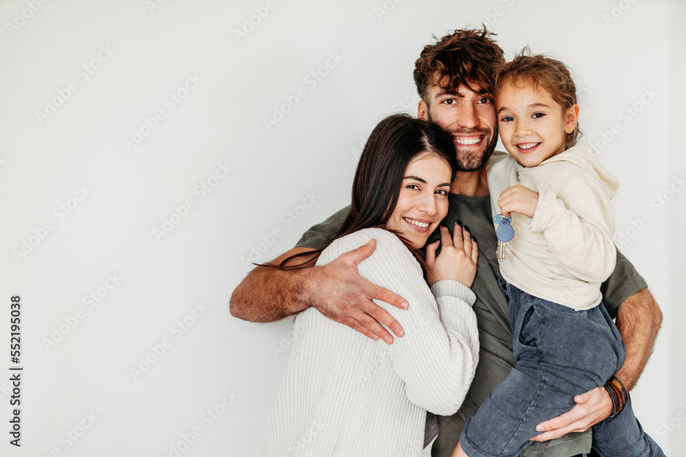 Portrait of Happy Caucasian family in their new empty home