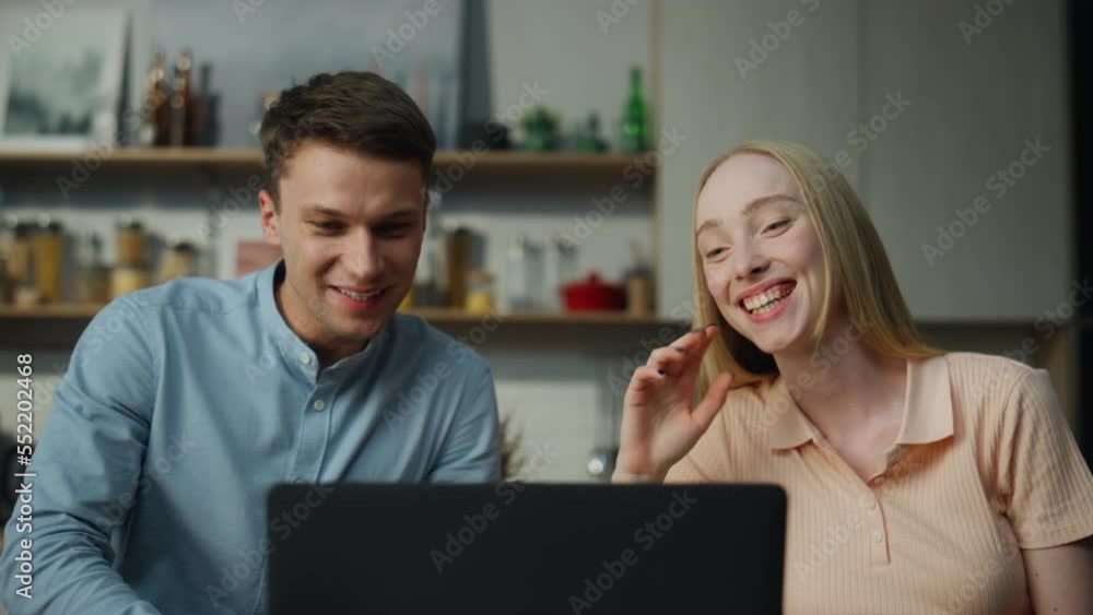 Married couple chatting online on video call from home sitting kitchen close up. Married couple chatting online on video call from home sitting kitchen close up.