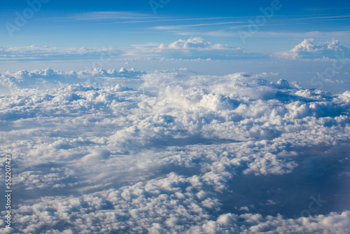 beautiful fluffy clouds from the window of the plane © Tsyb Oleh