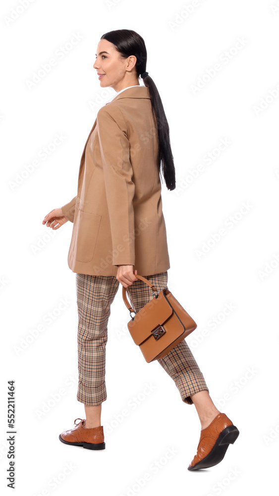 Young businesswoman with stylish bag walking on white background Young businesswoman with stylish bag walking on white background