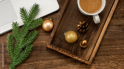 Christmas background with Laptop, coffee, fir branches, decorations.