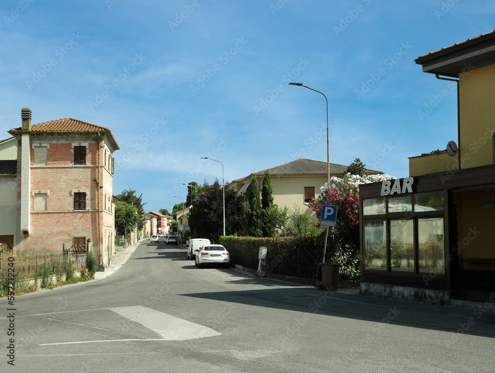 Beautiful street with buildings, cars and bar on sunny day Beautiful street with buildings, cars and bar on sunny day
