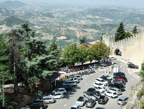 Aerial view of road with cars near castle on sunny day