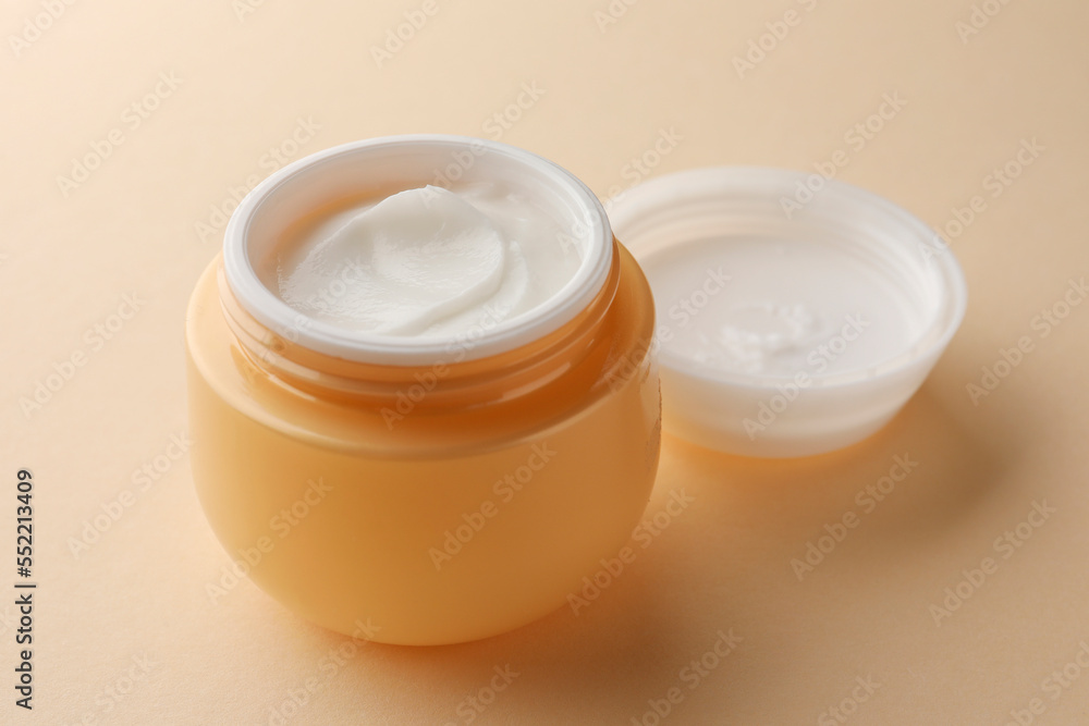Jar of face cream on beige background, closeup Jar of face cream on beige background, closeup