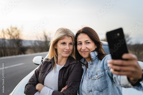 two women caucasian mature female friends taking selfie photos