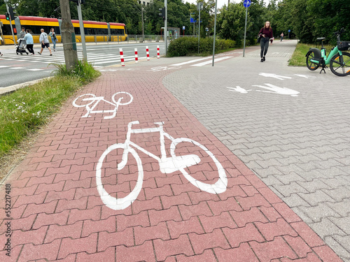 Street with road, pedestrian zone and red paved bicycle lane