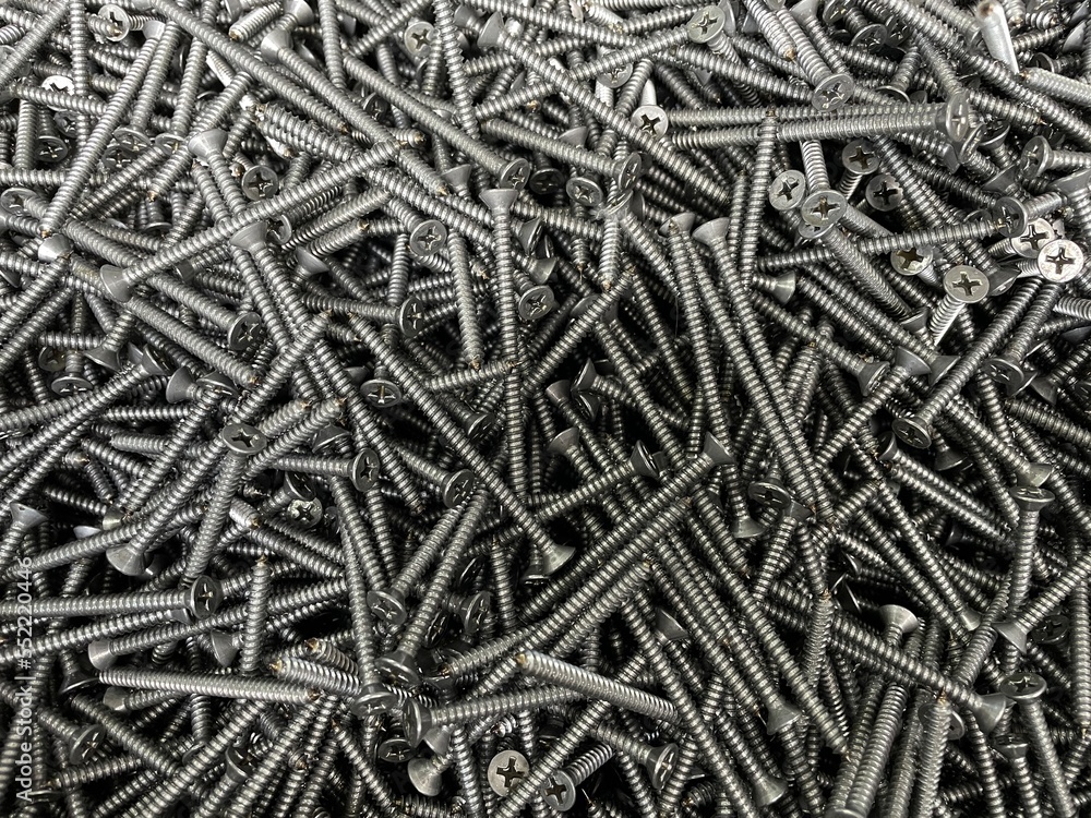 tapping screws made odd steel, metal screw, iron screw, chrome screw, screws as a background. Sharp screws on a black background. tapping screws made odd steel, metal screw, iron screw, chrome screw, screws as a background. Sharp screws on a black background.