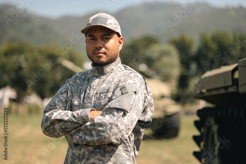 Fototapet Asian man special forces soldier standing against on the field Mission
