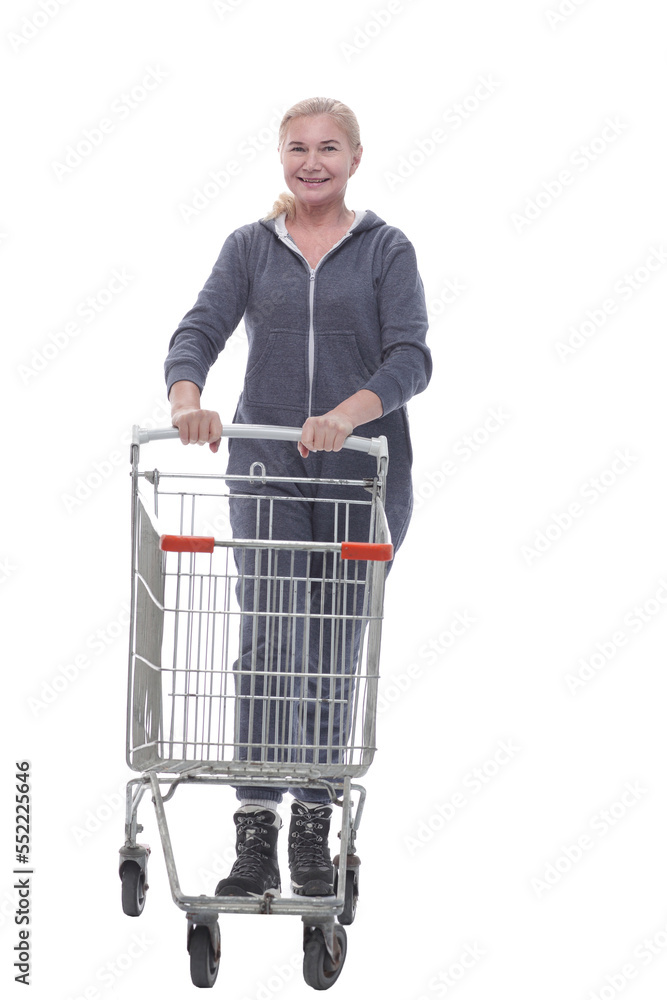 in full growth. smiling woman in casual clothes with shopping cart in full growth. smiling woman in casual clothes with shopping cart