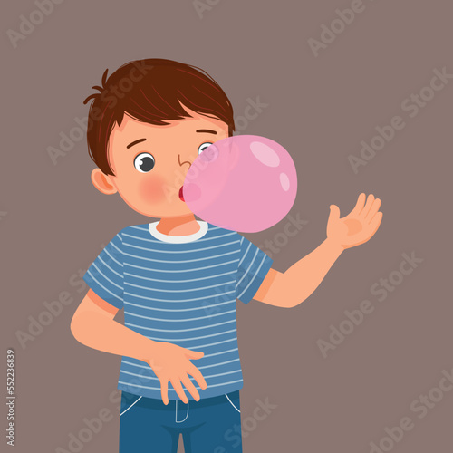 Happy little boy blowing chewing gum bubbles