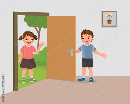 Cute little boy open the door for girl friend welcoming guest