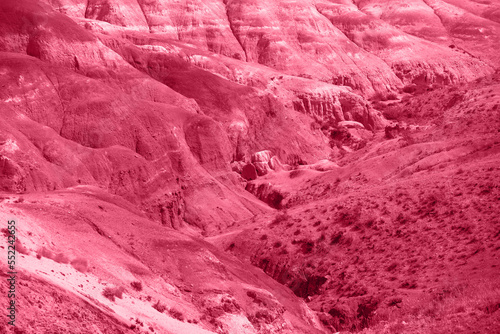 Trendy Color of the year 2023: Viva Magenta toned aerial drone view of eroded landform of Altai mountains