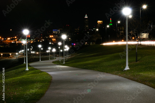 Nighttime park path with Cleveland city background and streetlamps. © Albert Jackson