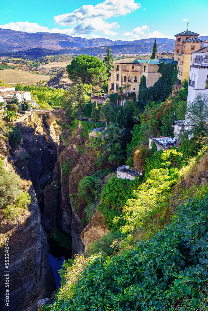 Beautiful mountainous landscape of Andalusian houses on the hills formed by the gorge of the river, Ronda Malaga.