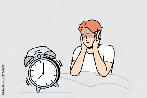 Guy in bed closes ears not to hear sounds in morning. Alarm clock is ringing. Getting up early for work, education. Sleeping man does not want to wake up. Vector linear colored isolated illustration.