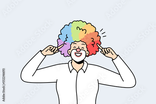 Portrait of male clown pointing with index fingers at his voluminous multicolored hairstyle, wig. LGBT smiling man with rainbow hairs. Gay pride. Front view. Vector minimalistic modern design.